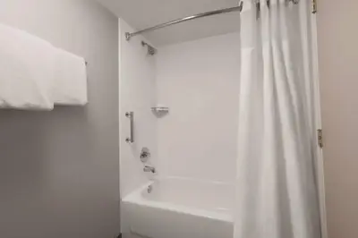 a bathroom with a shower and a white shower curtain at Courtyard by Marriott Denver Golden/Red Rocks in Golden