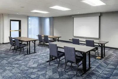 a conference room with tables and chairs and a whiteboard at Courtyard by Marriott Denver Golden/Red Rocks in Golden