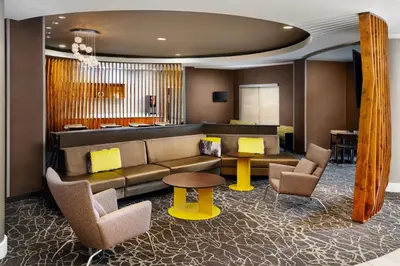 a lobby with a couch and chairs and a table at SpringHill Suites Boulder Longmont in Longmont