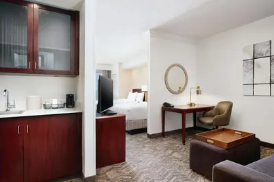 a hotel room with a bed and a living room at SpringHill Suites Boulder Longmont in Longmont