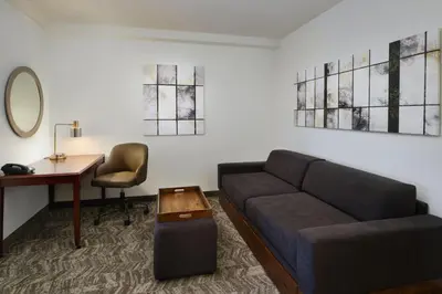 a living room with a couch and a desk at SpringHill Suites Boulder Longmont in Longmont