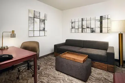 a living room with a couch and a table at SpringHill Suites Boulder Longmont in Longmont