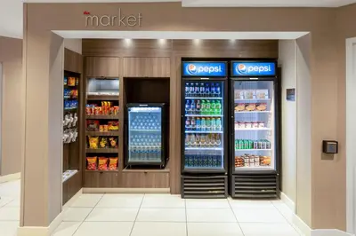 a grocery store aisle with two refrigerators and drinks at Residence Inn by Marriott Denver Golden/Red Rocks in Golden