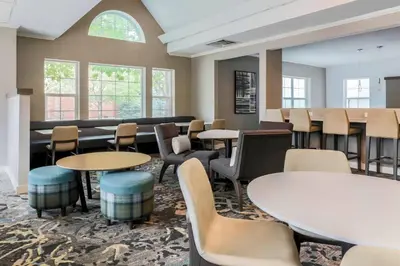 a waiting room with tables and chairs at Residence Inn by Marriott Denver Golden/Red Rocks in Golden
