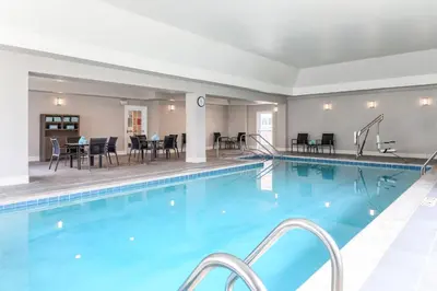 a pool with tables and chairs in a hotel at Residence Inn by Marriott Denver Golden/Red Rocks in Golden