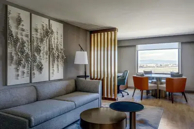 a living room with a couch and a table at Denver Airport Marriott at Gateway Park in Aurora
