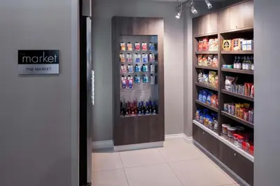 a store aisle with a drink cooler in a store at Residence Inn Denver Highlands Ranch in Highlands Ranch