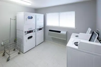 a laundry room with white appliances and a window at Residence Inn Denver Highlands Ranch in Highlands Ranch
