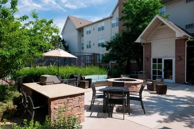 a patio with a table and chairs and an umbrella at Residence Inn Denver Highlands Ranch in Highlands Ranch