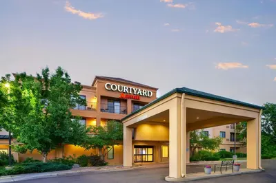 a hotel with a gated entrance in front of a building at Courtyard Boulder Longmont in Longmont