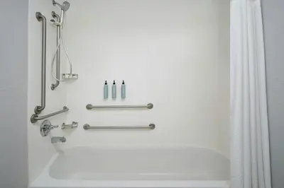 a bathroom with a tub and a shower at Courtyard Boulder Longmont in Longmont
