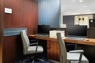 an office with a desk with a computer and chairs at Courtyard Boulder Longmont in Longmont