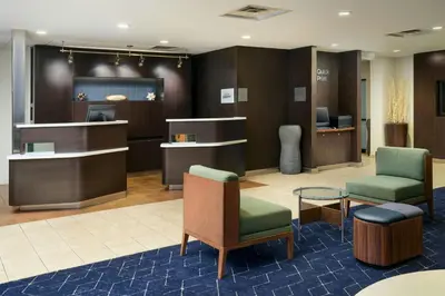 a lobby with a waiting room with chairs and tables at Courtyard Boulder Longmont in Longmont