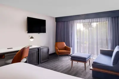 a hotel room with a bed and a desk and chair at Courtyard by Marriott Denver Southwest Lakewood in Lakewood
