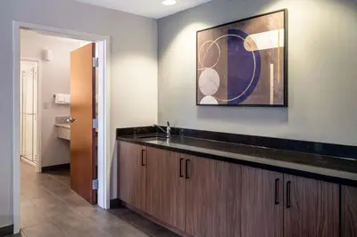 a bathroom with a sink and a painting on the wall at Courtyard by Marriott Denver Southwest Lakewood in Lakewood