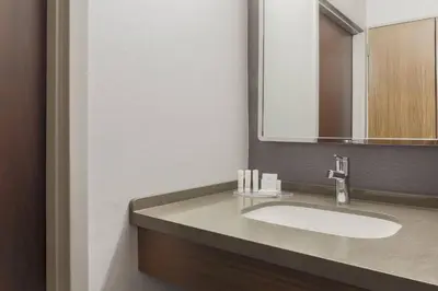 a bathroom with a sink and a mirror at Courtyard by Marriott Boulder Broomfield in Louisville