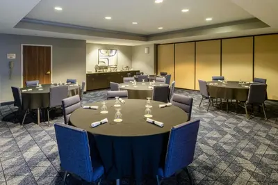 a conference room with tables and chairs in a room at Courtyard by Marriott Boulder Broomfield in Louisville