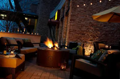 a living room with a fireplace with couches and fires at Renaissance Boulder Flatiron Hotel in Broomfield