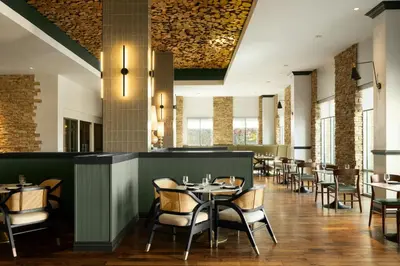 a dining room with tables and chairs at Renaissance Boulder Flatiron Hotel in Broomfield