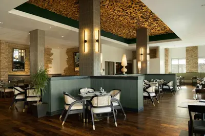 a dining room with tables and chairs in a restaurant at Renaissance Boulder Flatiron Hotel in Broomfield