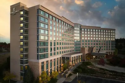 a rendering of a building with a sunset at Renaissance Boulder Flatiron Hotel in Broomfield
