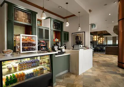 a coffee shop with a display of drinks and food at Renaissance Boulder Flatiron Hotel in Broomfield