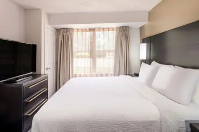 a hotel room with a bed and a television at Residence Inn Denver Southwest/Lakewood in Lakewood