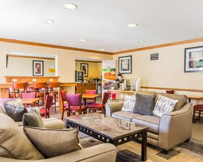 a living room with couches and a table at Quality Inn & Suites Golden - Denver West in Lakewood