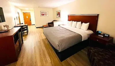 a hotel room with a large bed and a desk at Quality Inn & Suites Golden - Denver West in Lakewood
