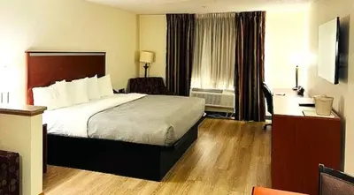 a hotel room with a bed and a desk at Quality Inn & Suites Golden - Denver West in Lakewood