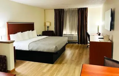 a hotel room with a bed and a desk at Quality Inn & Suites Golden - Denver West in Lakewood
