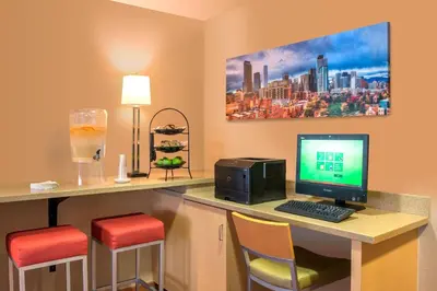 a room with a desk with a computer and two chairs at TownePlace Suites by Marriott Boulder Broomfield/Interlocken in Broomfield