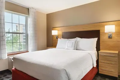 a bedroom with a large bed and a window at TownePlace Suites by Marriott Boulder Broomfield/Interlocken in Broomfield