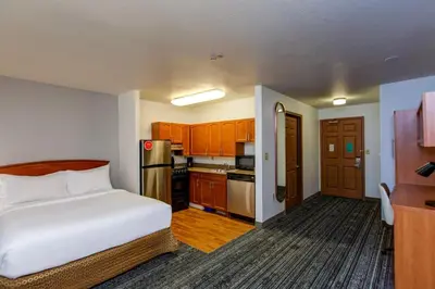 a small room with a bed and a kitchen at TownePlace Suites Denver Southwest/Littleton in Littleton