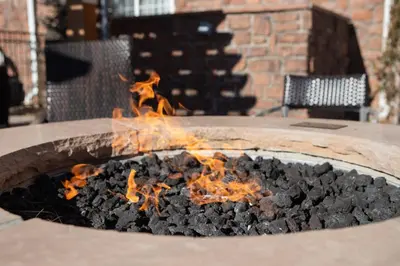 a fire pit with fire charcoal in it at TownePlace Suites Denver Southwest/Littleton in Littleton