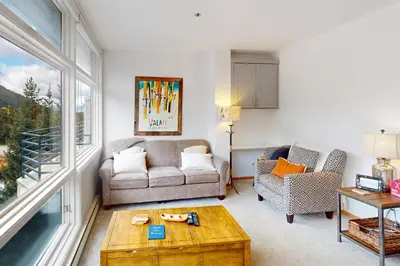 a living room with a couch and a table at River Bank Lodge 2924 in Keystone