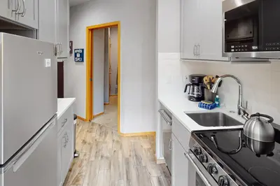 a kitchen with a sink and a refrigerator at River Bank Lodge 2924 in Keystone