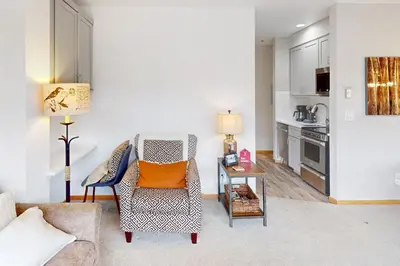 a living room with a chair and a table at River Bank Lodge 2924 in Keystone