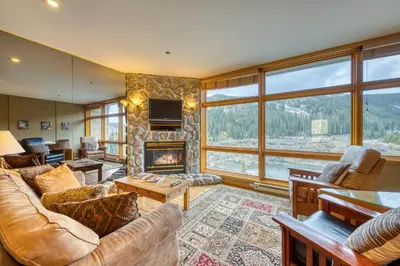 a living room with a couch and a fireplace at River Bank Lodge 2919 in Keystone