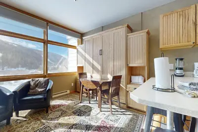 a kitchen with a table and chairs and a large window at River Bank Lodge 2919 in Keystone