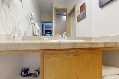 a bathroom with a sink and a mirror at River Bank Lodge 2919 in Keystone