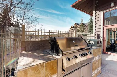 a grill on a patio outside of a house at Red Hawk Lodge 2200 in Dillon