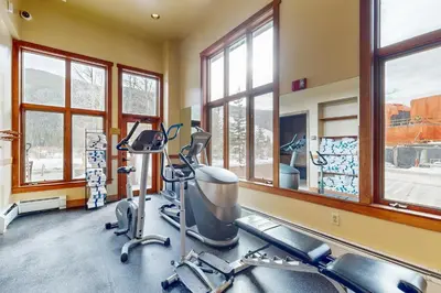 a gym with treadmills and ellipticals and windows at Red Hawk Lodge 2200 in Dillon