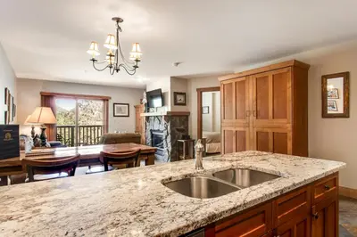 a kitchen with a sink and a living room at Red Hawk Lodge 2286 in Dillon