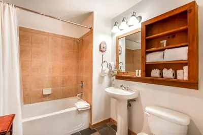 a bathroom with a sink and a toilet and a bath tub at Red Hawk Lodge 2286 in Dillon
