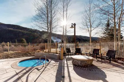 a patio with a hot tub and a table and chairs at Red Hawk Lodge 2286 in Dillon