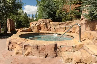 a large stone pool in a rock wall at Springs 8860 in Keystone