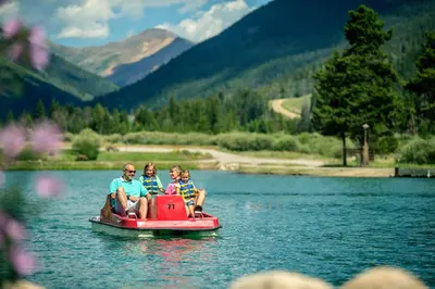 a group of people sitting on a boat on a lake at Springs 8860 in Keystone