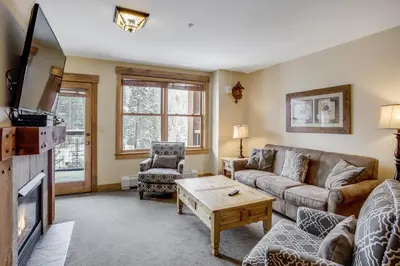 a living room with a couch and a table at Springs 8860 in Keystone