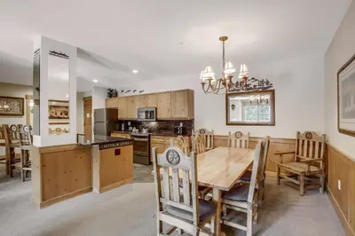 a kitchen and dining room with a table and chairs at Springs 8860 in Keystone